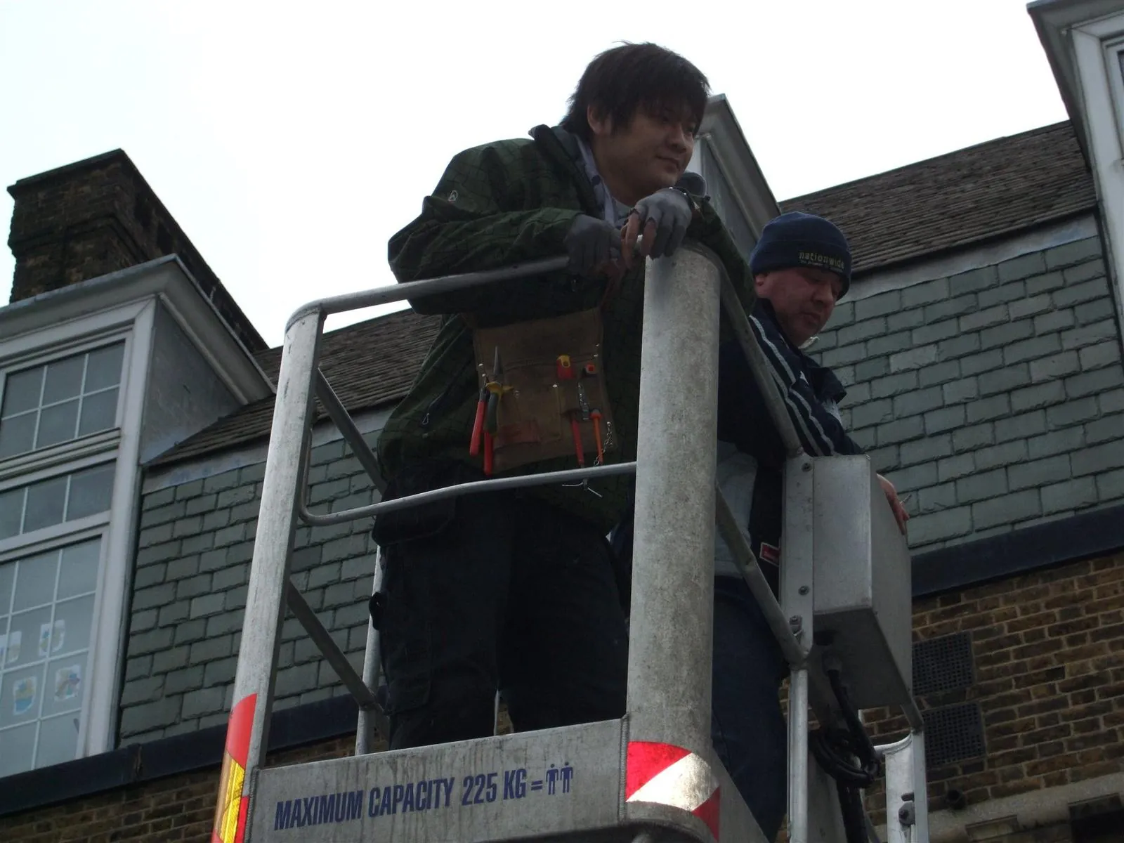 Electricians working from an aerial lift