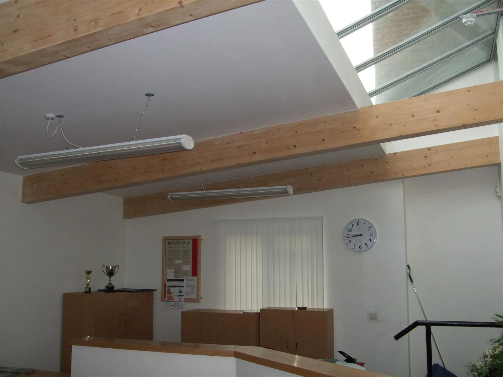 Suspended tube lighting installed in a school lobby in East London