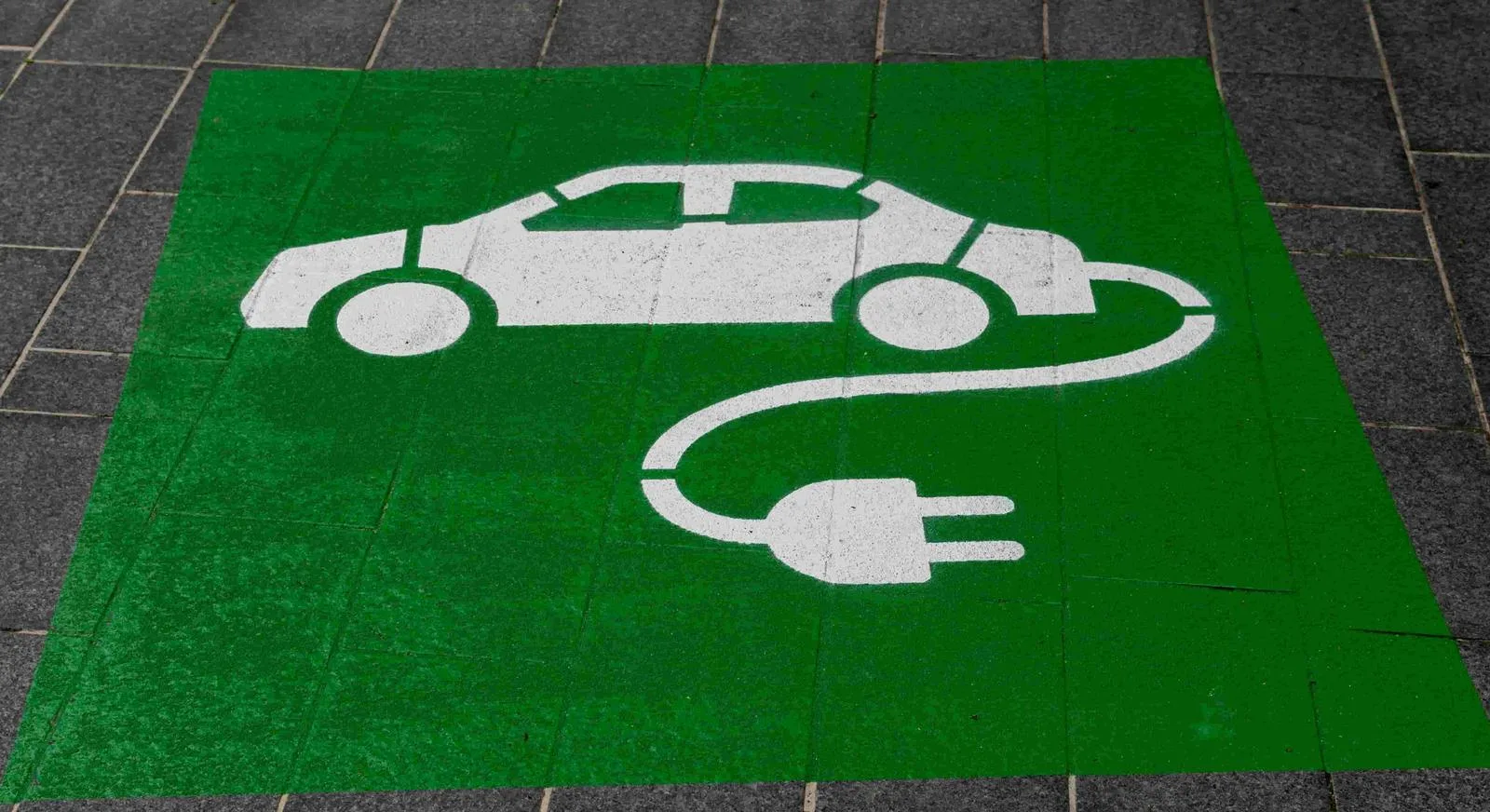 EV charging bay marked out with a green car-and-plug symbol