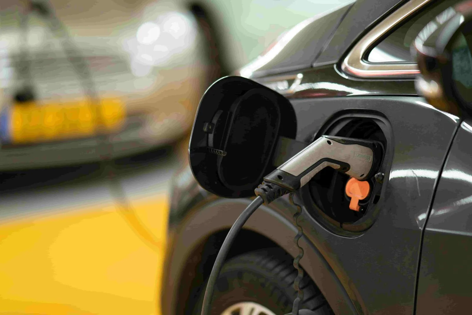 Charging cable connected to an electric car in a car park