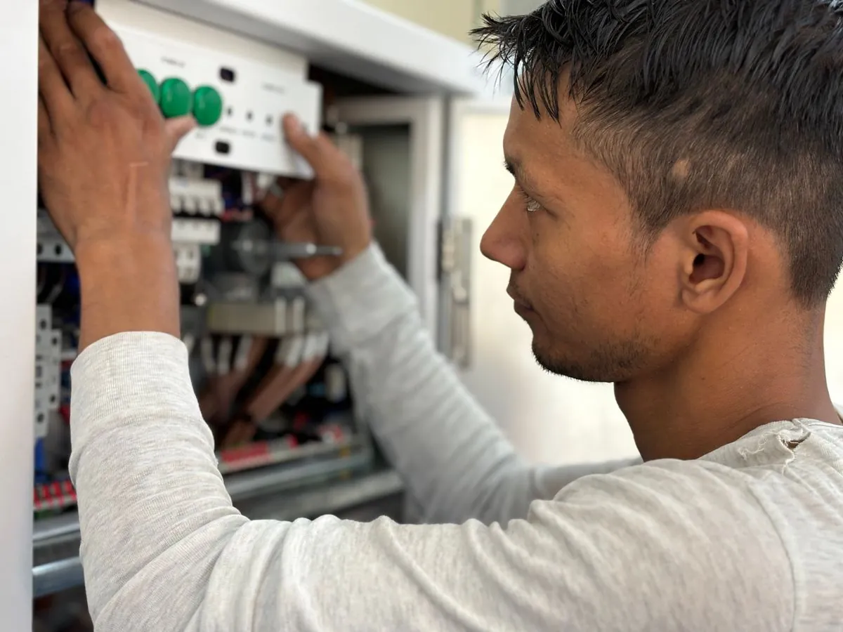 Electrician wiring an electrical panel