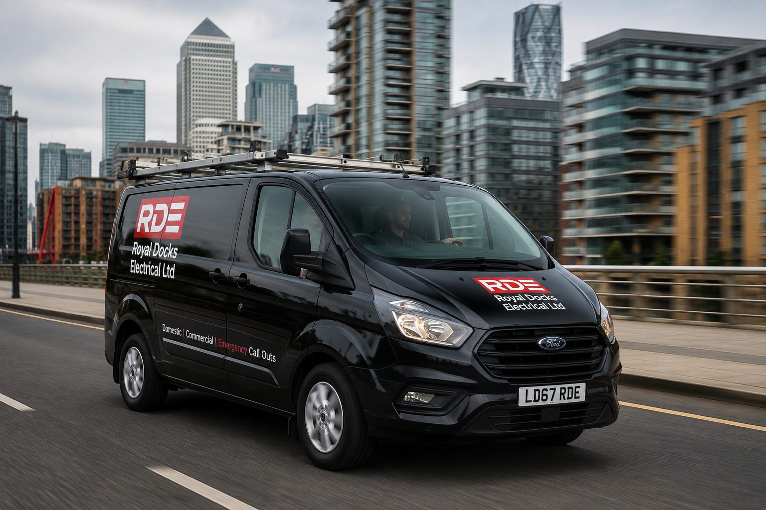 Royal Docks Electrical van on the road by the Canary Wharf skyline in East London