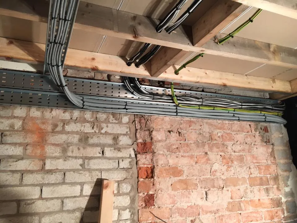Cable tray and rewire cabling installed in a brick building in E15