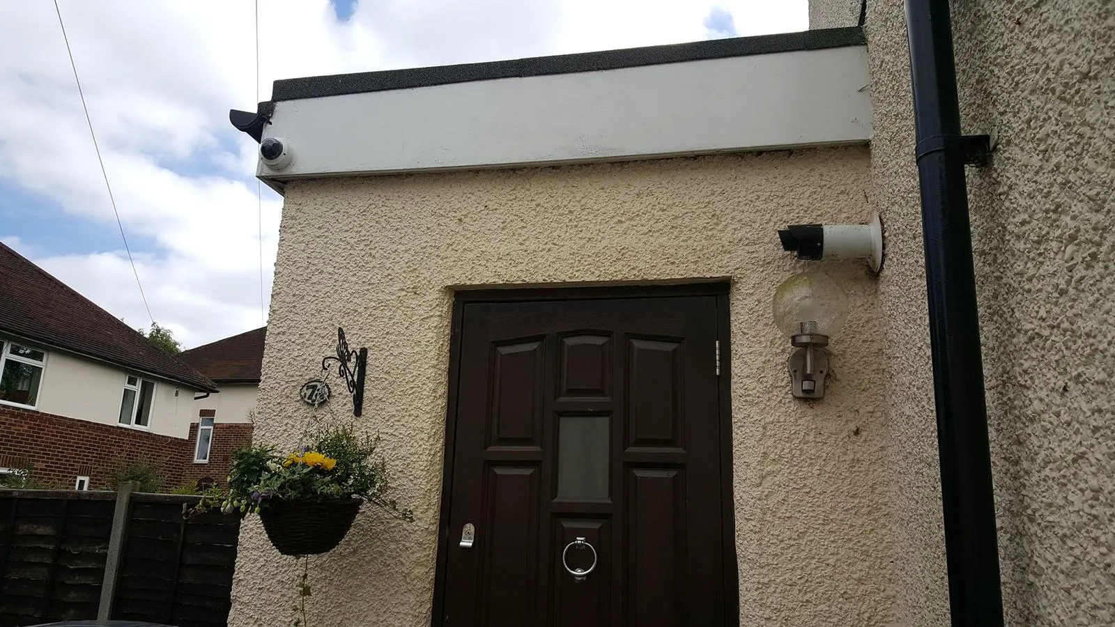 CCTV dome camera installed above the front door of a house