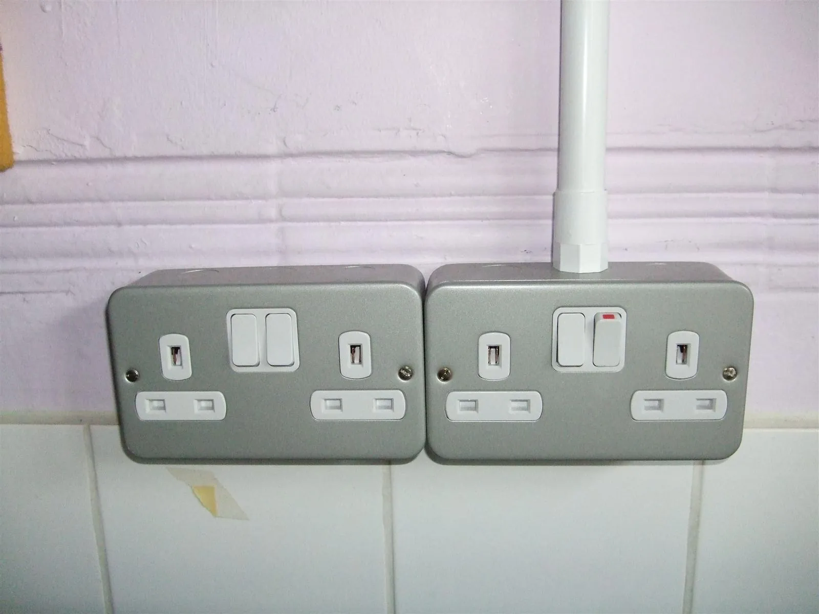 Metal-clad double sockets installed on a wall