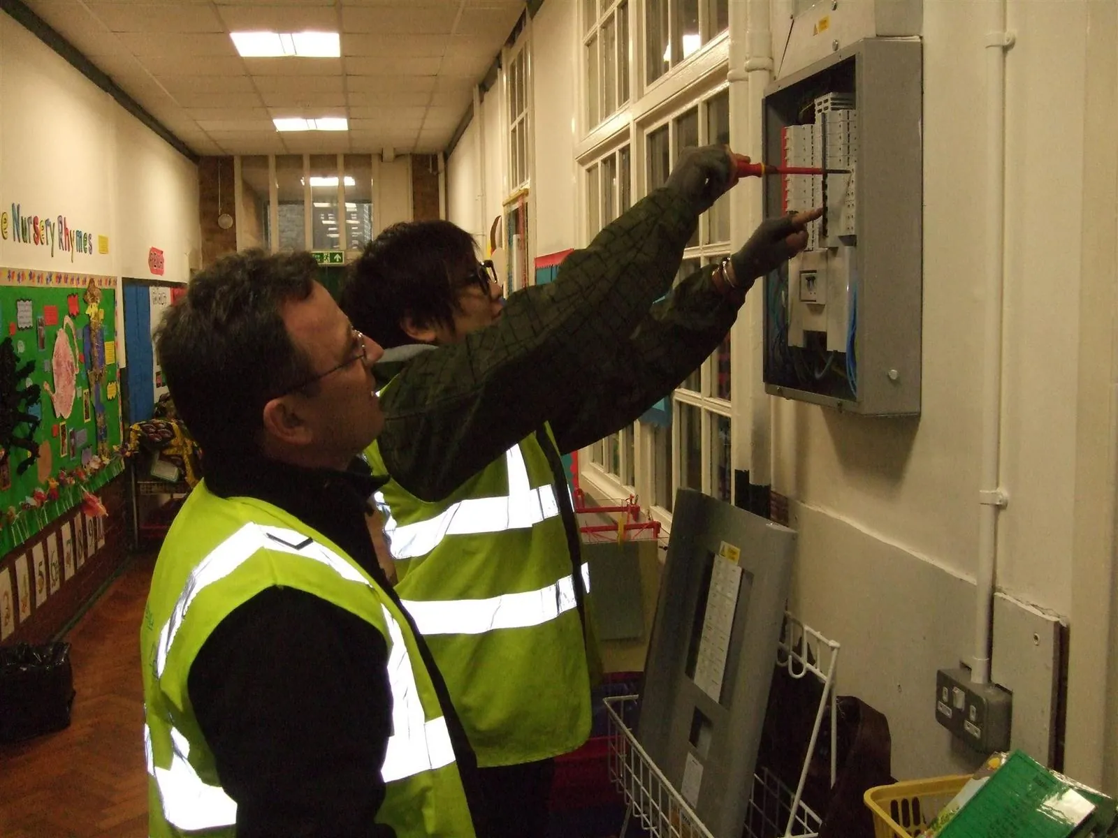 Electricians testing a distribution board